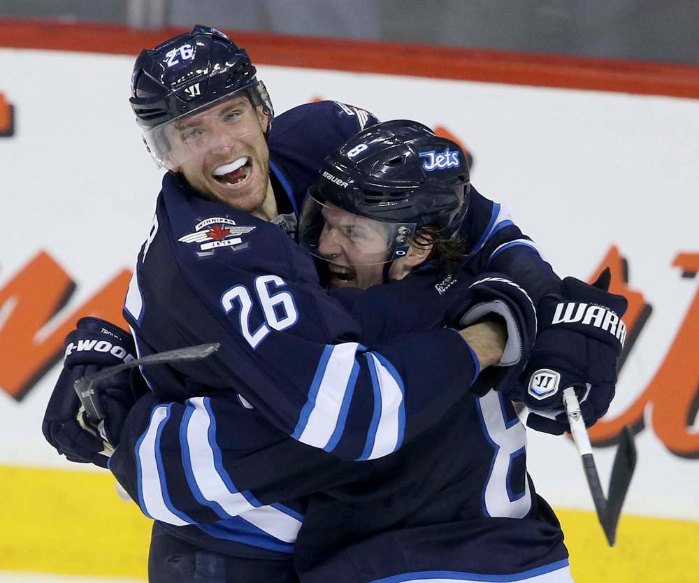 TREVOR HAGAN / WINNIPEG FREE PRESS FILES
Winnipeg Jets' Blake Wheeler (26) and Jacob Trouba (8) celebrate after Trouba scored a game-winning goal in overtime against the Edmonton Oilers in a 2014 game.