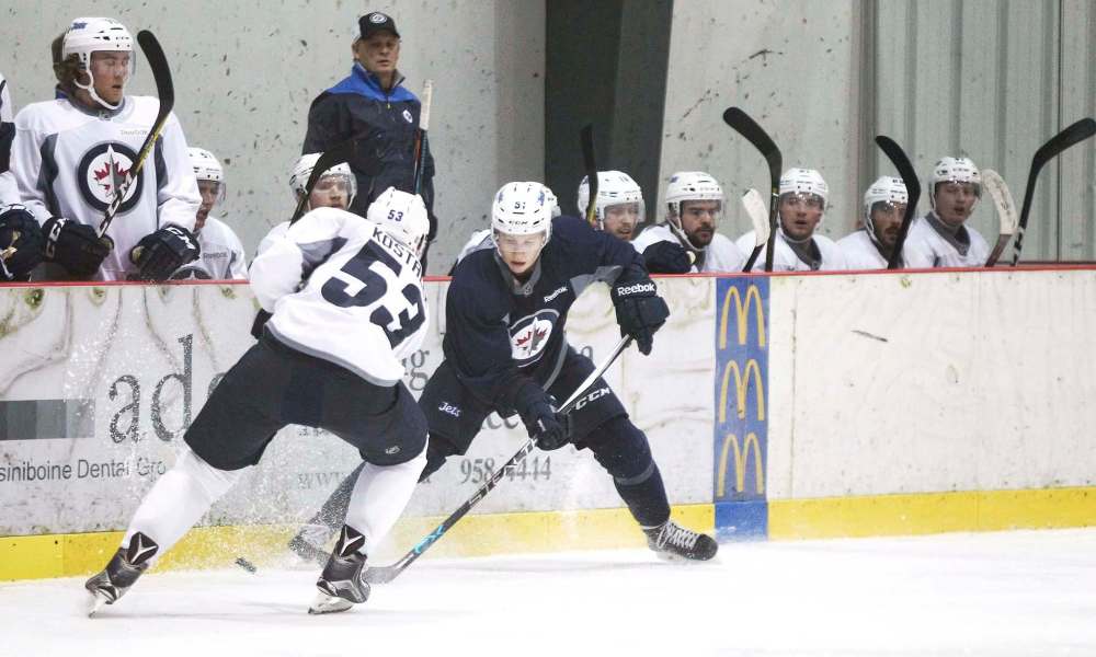 MIKE DEAL / WINNIPEG FREE PRESSWinnipeg Jets' Jan Kostalek (53) and Luke Green (51) battle for the puck during a scrimmage at Jets training camp Monday.