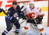 BORIS MINKEVICH / WINNIPEG FREE PRESS
Winnipeg Jets defenceman Brendan Kichton and Calgary Flames winger Garnet Hathaway duel in front of Jets goalie Eric Comrie Tuesday night at the MTS Centre.