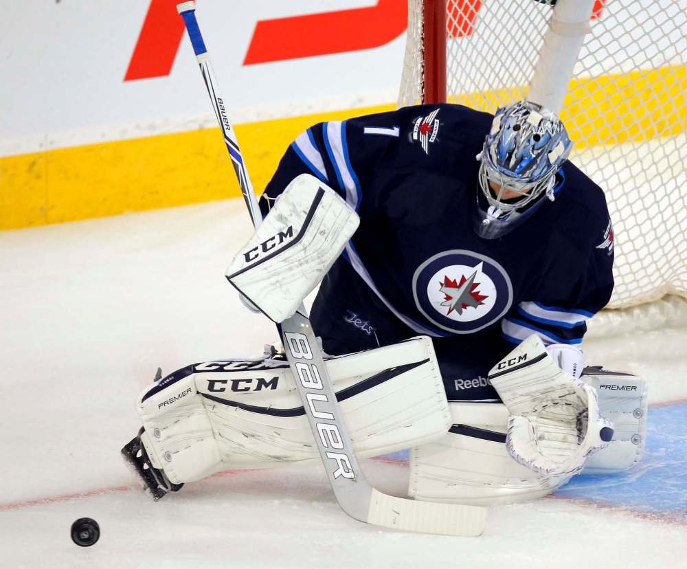 BORIS MINKEVICH / WINNIPEG FREE PRESS
Jets goaltender Eric Comrie kicks out a shot Tuesday.