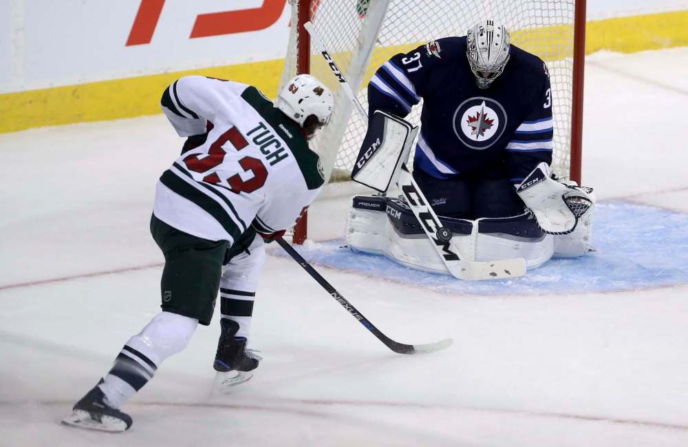 Trevor Hagan / The Canadian Press
Winnipeg Jets goaltender Connor Hellebuyck stops a shot by Minnesota Wild's Alex Tuch during pre-season NHL hockey at the MTS Centre Thursday.