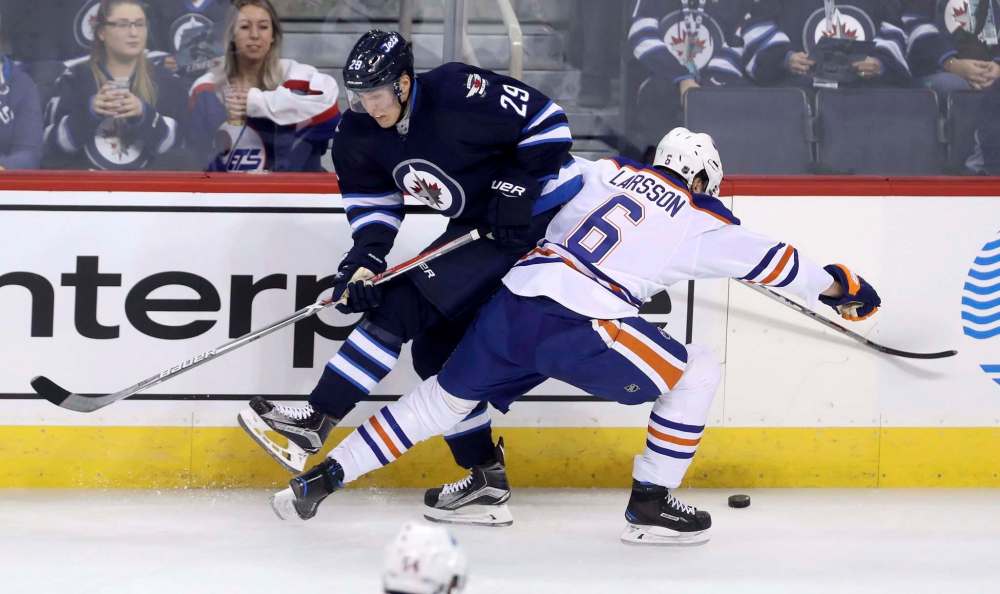 TREVOR HAGAN / THE CANADIAN PRESS
Patrik Laine collides with Edmonton Oilers' Adam Larsson during the first period.