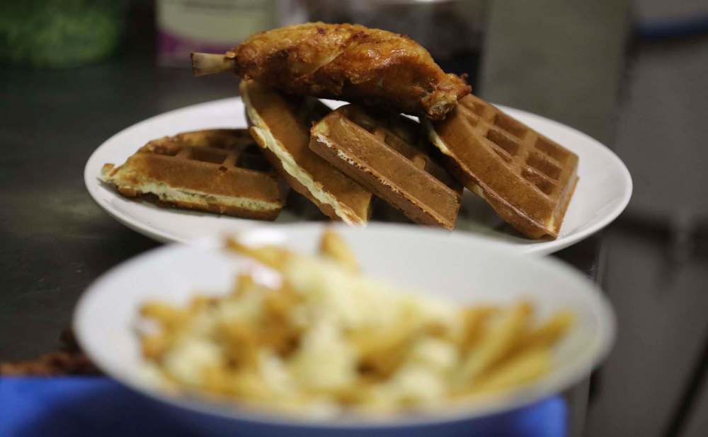 TREVOR HAGAN / WINNIPEG FREE PRESS
Chicken & Waffles being prepared in the kitchen at Creme de L'Essence.