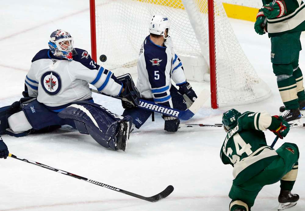 Jim Mone / The Associated Press
A shot by Minnesota Wild forward Mikael Granlund misses the net as Winnipeg Jets goalie Michael Hutchinson and defenceman Mark Stuart defend during first-period NHL action Saturday in St. Paul, Minn.