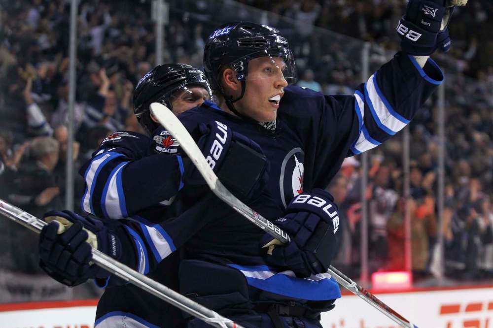 MIKE DEAL / WINNIPEG FREE PRESS
Winnipeg Jets' Patrik Laine (29) celebrates his overtime hat-trick goal against the Toronto Maple Leafs with Nikolaj Ehlers (27) at the MTS Centre Wednesday evening.