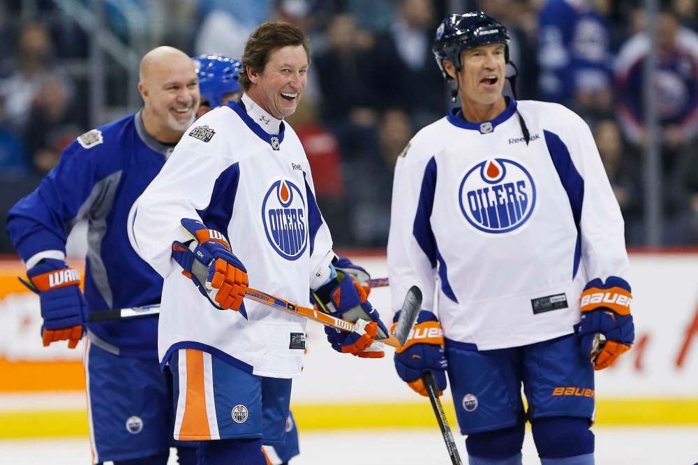 John Woods / The Canadian Press
Former Edmonton Oilers, from left, Charlie Huddy joke around during a practice for the NHL's Heritage Classic Alumni game in Winnipeg on Friday.
