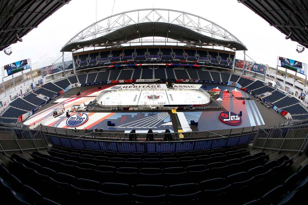 JOHN WOODS / THE CANADIAN PRESS
Workers put the finishing touches to the NHL's Heritage Classic outdoor rink in Winnipeg on Thursday.