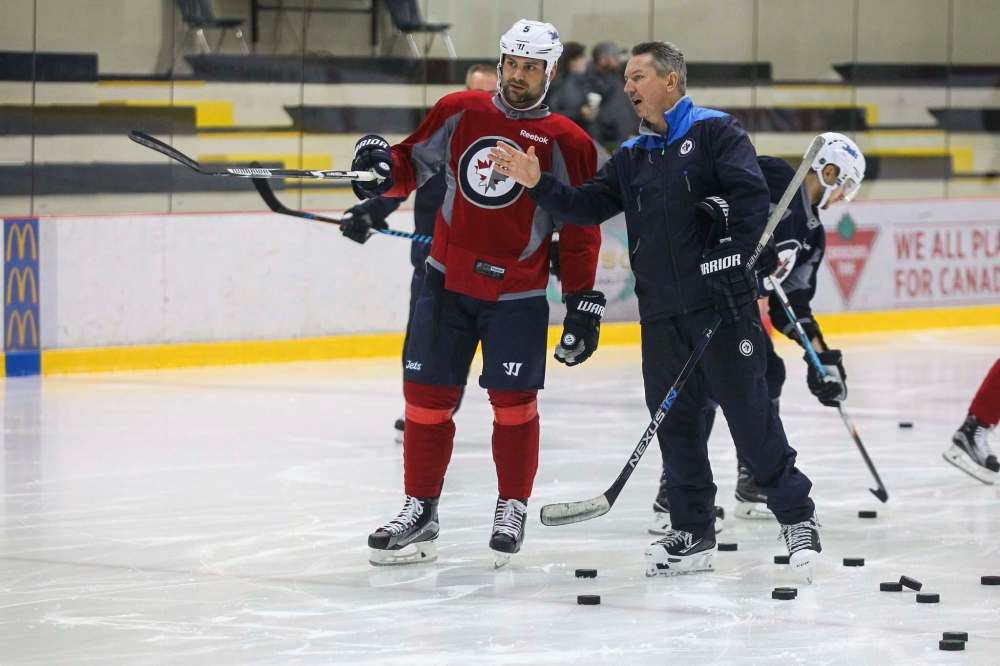 MIKE DEAL / WINNIPEG FREE PRESS
Winnipeg Jets' Mark Stuart (5) talks to goaltending coach Wade Flaherty during practice at the MTS IcePlex Monday morning.