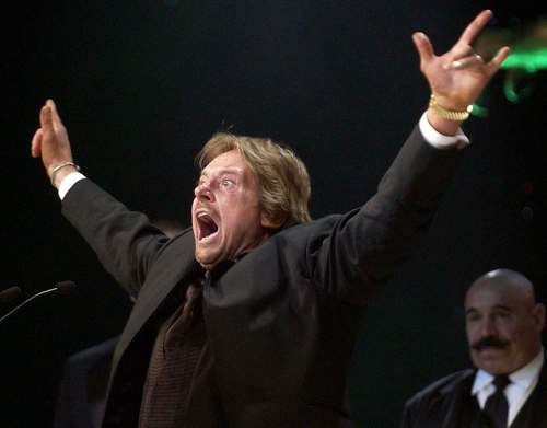 Matt Sayles / The Associated Press files
Wrestler Rowdy Roddy Piper gestures to the crowd after being inducted into the WWE Hall of Fame.