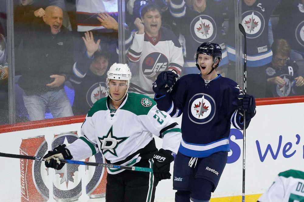 John Woods / The Canadian Press
Winnipeg Jets' Kyle Connor celebrates his first NHL goal as Dallas Stars' Adam Cracknell looks on Thursday.
