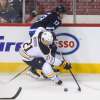 MIKE DEAL / WINNIPEG FREE PRESS
The Winnipeg Jets' Brandon Tanev (13) is forced off the puck by Buffalo Sabres' forward Kyle Okposo (#21) during Sunday's game.