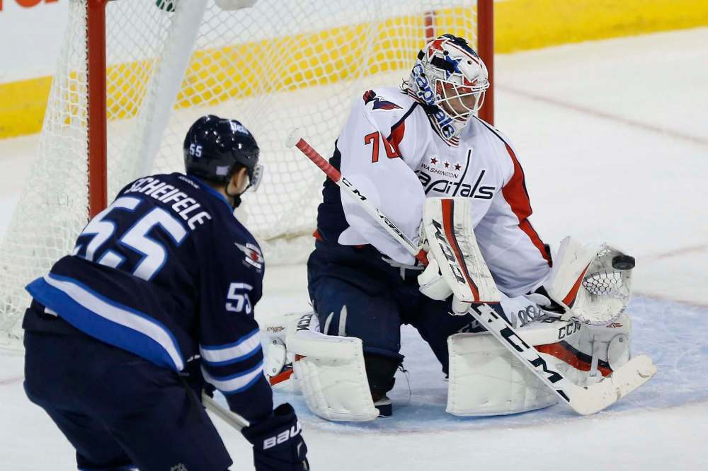 John Woods / The Canadian Press
Washington Capitals goaltender Braden Holtby (70) saves a shot by Winnipeg Jets' Mark Scheifele (55) during first period NHL action in Winnipeg on Tuesday, November 1, 2016.