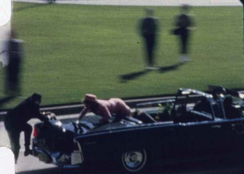 Zapruder Film ©, The Sixth Floor Museum at Dealey Plaza
In a still from Abraham Zapruder&rsquo;s 8mm film, Secret Service agent Clint Hill (left) and Jacqueline Kennedy are seen scrambling after then-president John F. Kennedy was shot.