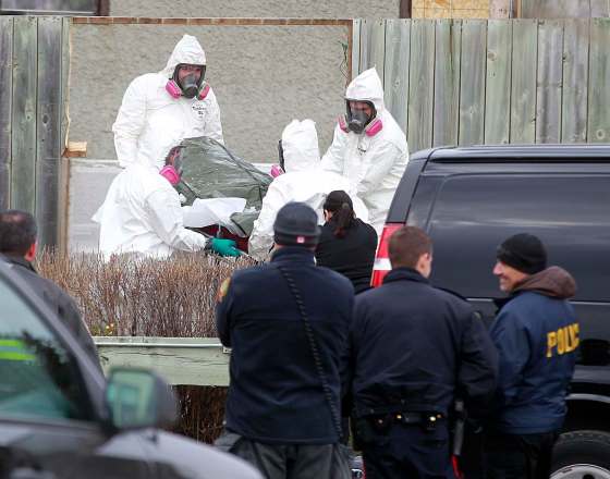 PHIL HOSSACK / WINNIPEG FREE PRESSOfficials remove three bodies from a house on Petriw Bay in the Maples Wednesday afternoon.