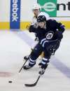 Trevor Hagan / The Canadian Press
Jets defenceman Jacob Trouba carries the puck up ice against the Predators Sunday.
