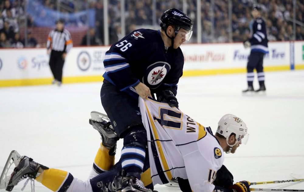 TREVOR HAGAN / THE CANADIAN PRESS
Winnipeg Jets' Marko Dano (56) stands over Nashville Predators' Mattias Ekholm (14) after taking exception to his hit during the second period of Sunday's game in Winnipeg.