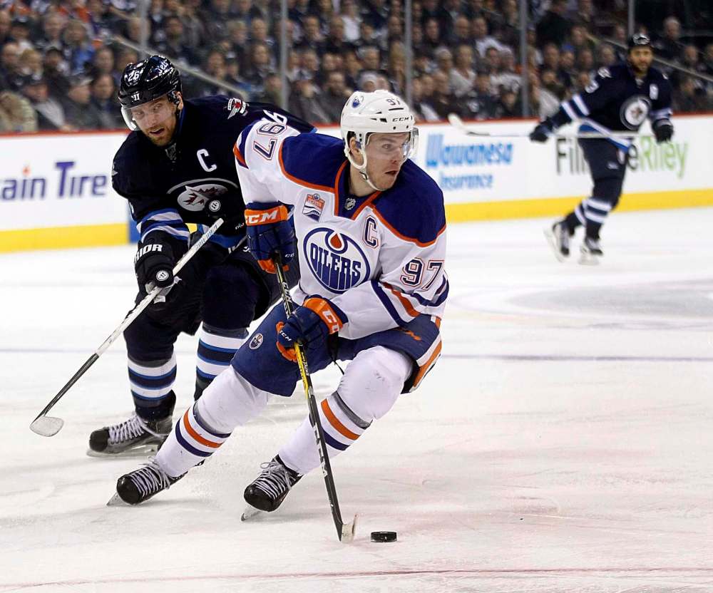 PHIL HOSSACK / WINNIPEG FREE PRESS
Winnipeg Jets captain Blake Wheeler trails Edmonton Oilers captain Connor McDavid Thursday at the MTS Centre.