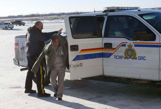 WAYNE GLOWACKI / WINNIPEG FREE PRESSA Mountie escorts Vanessa Bushie into the community hall at Peguis First Nation for her preliminary hearing Monday. She is accused in the death of her young daughter, Kierra.