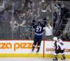 Nikolaj Ehlers celebrates the first of his two third-period goals against the Colorado Avalanche. Patrik Laine and Mark Scheifele drew assists on the goal.