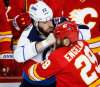 Jeff McIntosh / The Canadian Press
Winnipeg Jets Chris Thorburn lands a punch on Calgary Flames Deryk Engelland as the two fight in Calgary Dec. 10.