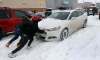 WAYNE GLOWACKI / WINNIPEG FREE PRESS
Yi Fan Yang and Nelson Tam,right, lend a hand to a Boxing Day shopper stuck in the snow in the strip mall parking lot along St. James St. Monday morning.