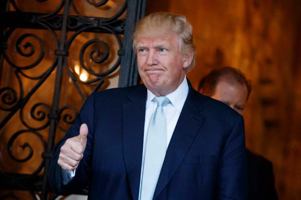 Evan Vucci / The Associated Press
U.S. president-elect Donald Trump gives a thumbs up to journalists at Mar-a-Lago in Palm Beach, Fla., Wednesday.
