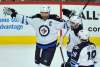 PAUL BEATY / AP
Winnipeg Jets' Blake Wheeler (26) celebrates with teammates Mathieu Perreault (85) and Bryan Little (18) after scoring a goal during the first period of an NHL hockey game against the Chicago Blackhawks Tuesday, Dec. 27, 2016, in Chicago.