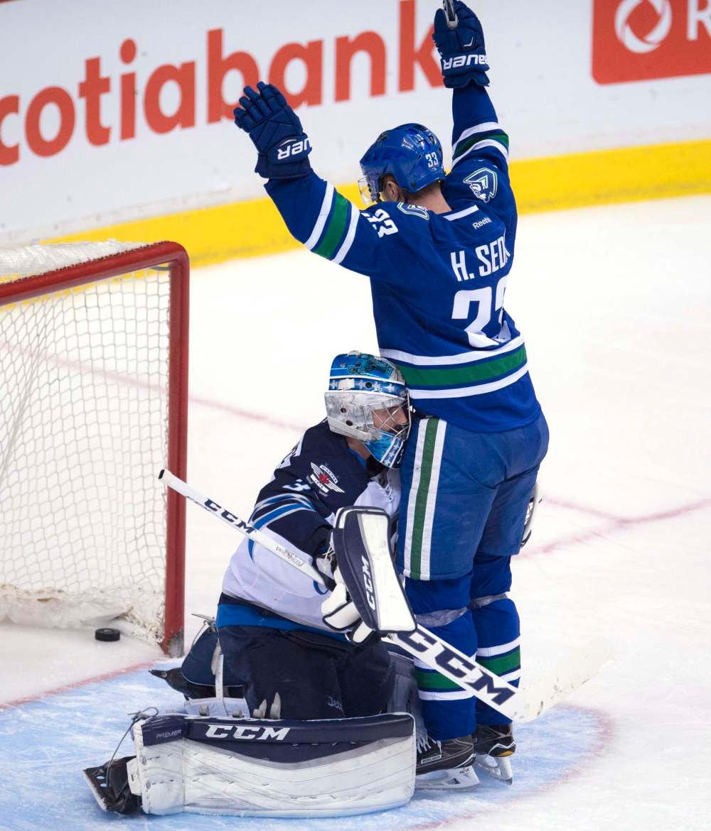 Jonathan Hayward / THE CANADIAN PRESS files
Vancouver Canucks centre Henrik Sedin celebrates teammate Jannik Hansen’s goal on Jets goalie Connor Hellebuyck. Such celebrations have been happening a bit too often lately.