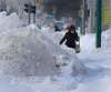 WAYNE GLOWACKI / WINNIPEG FREE PRESS
A woman struggles around a pile of snow on a sidewalk on Portage Avenue near Sherburn Street on Tuesday.