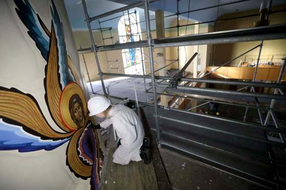 Photos by TREVOR HAGAN / WINNIPEG FREE PRESSChristina Prokopchuk restores one of the many artworks damaged by a fire last July at Holy Trinity Ukrainian Orthodox Metropolitan Cathedral on Main Street.
