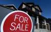 Sean Kilpatrick
/ The Canadian Press
A sign advertises a new home for sale in Carleton Place, Ont., on March 17, 2015. The head of the federal housing agency is raising a red flag about the state of Canada&rsquo;s real estate sector, saying affordability concerns have spilled over from the country&rsquo;s two most expensive cities to nearby markets.