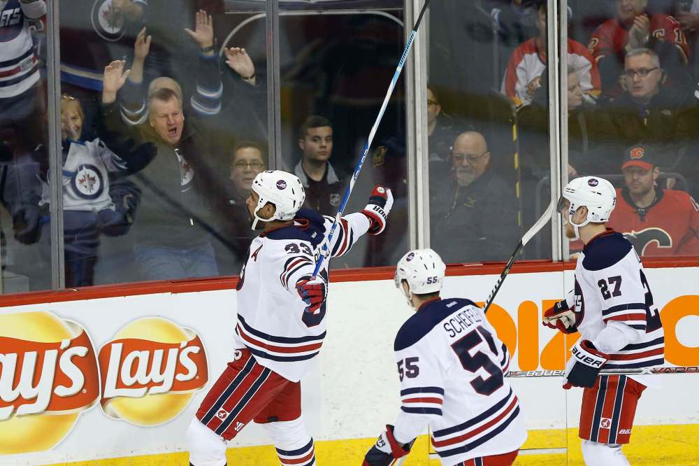 JOHN WOODS / WINNIPEG FREE PRESS
Winnipeg Jets' Dustin Byfuglien (33), Mark Scheifele (55) and Nikolaj Ehlers (27) celebrate Byfuglien's goal against the Calgary Flames during first period NHL action in Winnipeg on Monday. at the MTS Centre.