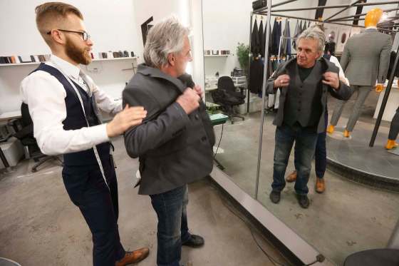 JOHN WOODS / WINNIPEG FREE PRESSPhil Goss, facility manager at Main Street Project and former client, is fitted for a new suit by Brett Kuchciak, regional sales manager at EPH Apparel, on Monday. Clients and former clients are being fitted to walk the runway in The Runway To Change, a Main Street Project fundraising fashion show.