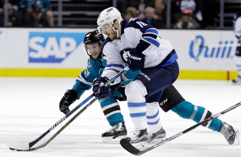 Winnipeg Jets' Bryan Little, right, works against San Jose Sharks' Melker Karlsson during the third period of an NHL hockey game, Monday, Jan. 16, 2017, in San Jose, Calif. (AP Photo/Marcio Jose Sanchez)