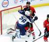 Fred Chartrand / The Canadian Press
Blake Wheeler takes is shoved by Ottawa Senators' Marc Methot in front of the Senators' net during the second period.