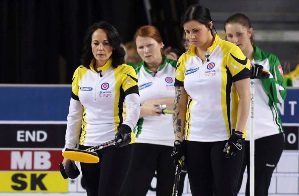 Sean Kilpatrick / The Canadian Press
Manitoba skip Michelle Englot (left) talks strategy with third Kate Cameron as Saskatchewan third Deanna Doig, middle back, and skip Penny Barker look on during the Scotties Tournament of Hearts in St. Catharines, Ont., Sunday.