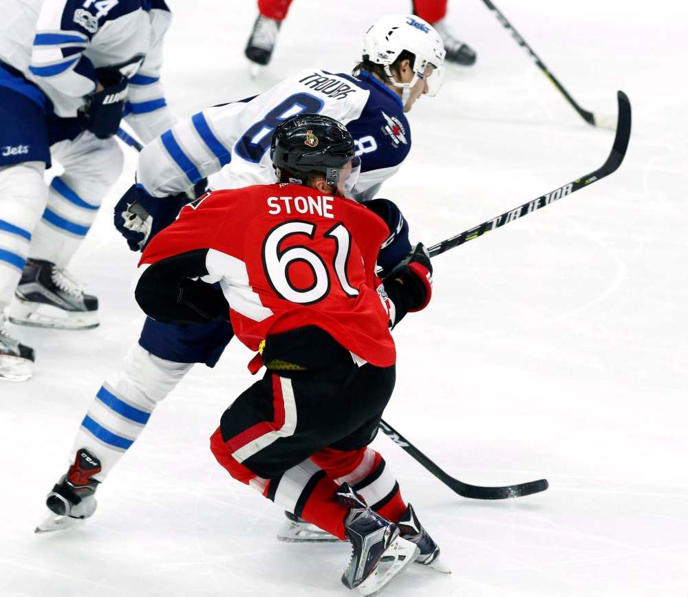 THE CANADIAN PRESS/Fred Chartrand
Ottawa Senators' Mark Stone (61) is hit hard by Winnipeg Jets' Jacob Trouba (8) during third period NHL hockey action in Ottawa on, Sunday February 19, 2017.