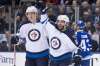 CHRIS YOUNG / THE CANADIAN PRESS
Winnipeg Jets right wing Patrik Laine, left, celebrates with Mathieu Perreault after scoring his team's opening goal during first period NHL hockey action against the Toronto Maple Leafs, in Toronto on Tuesday.