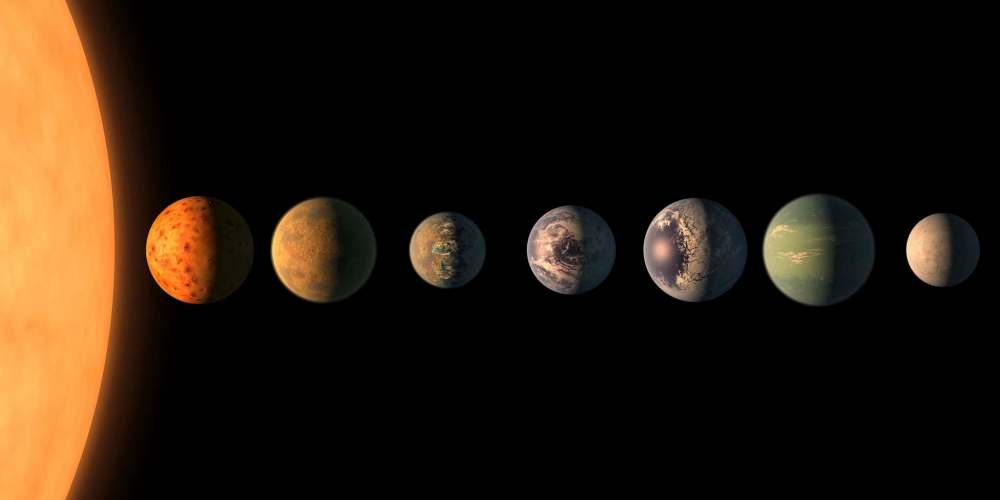 NASA / JPL-Caltech illustration
The Trappist-1 star, an ultracool dwarf, is orbited by seven Earth-size planets. Researchers say the star would shine 200 times dimmer than our sun and it would glow red.