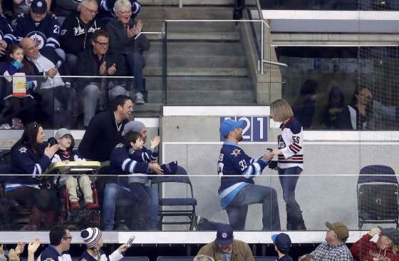 TREVOR HAGAN / THE CANADIAN PRESSA Winnipeg Jets fan proposes to his partner as the team plays the Minnesota Wild during the first period of Tuesday's game in Winnipeg.