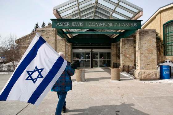 MIKE DEAL / WINNIPEG FREE PRESSAbout 20 people joined the rally in front of the Rady Jewish Community Centre Sunday.