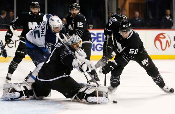 Kathy Willens / The Associated PressNew York Islanders defenseman Adam Pelech (50) and New York Islanders goalie Thomas Greiss defend the goal as Winnipeg Jets center Mark Scheifele looks for an opening during the first period of an NHL hockey game, Thursday, March 16, 2017, in New York,
