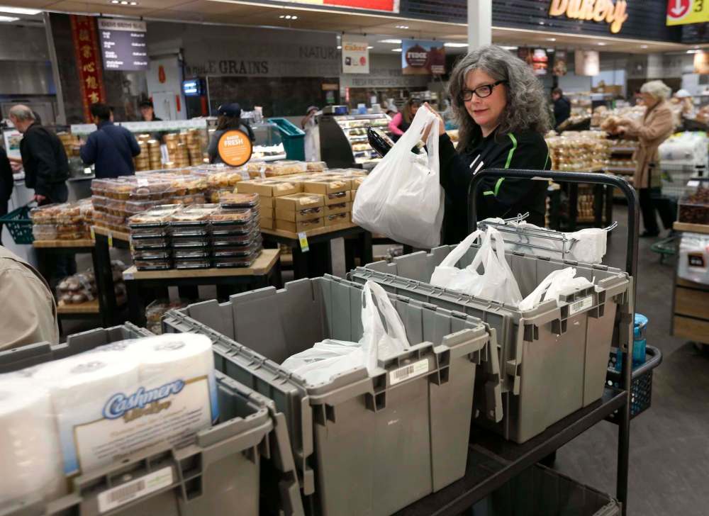 WAYNE GLOWACKI / WINNIPEG FREE PRESS
Save-On-Foods employee Lisa Smith fills an online shopper’s grocery order at the company's store in the Northgate shopping centre on McPhillips Street.