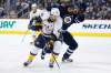 Nashville Predators' James Neal (18) and Winnipeg Jets' Dustin Byfuglien (33) chase down a loose puck during the second period (John Woods / The Canadian Press)