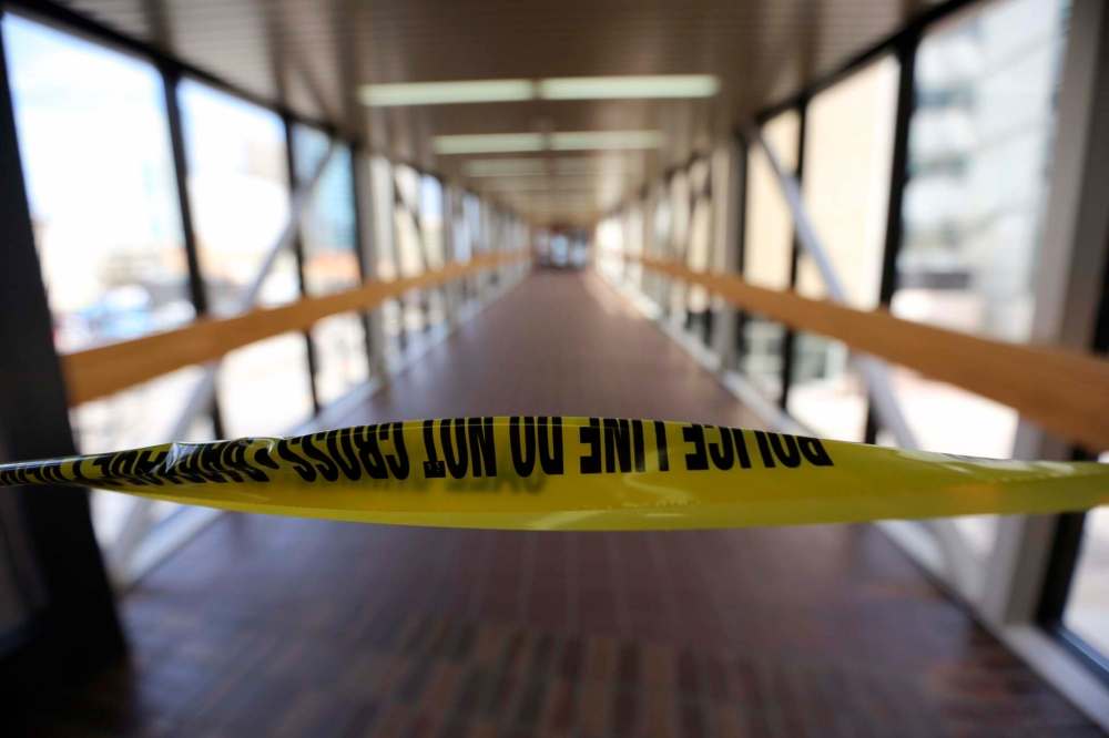 TREVOR HAGAN / WINNIPEG FREE PRESS
Police tape blocking the skywalk between the Millennium Library and the Police Headquarters following a shooting, Monday.