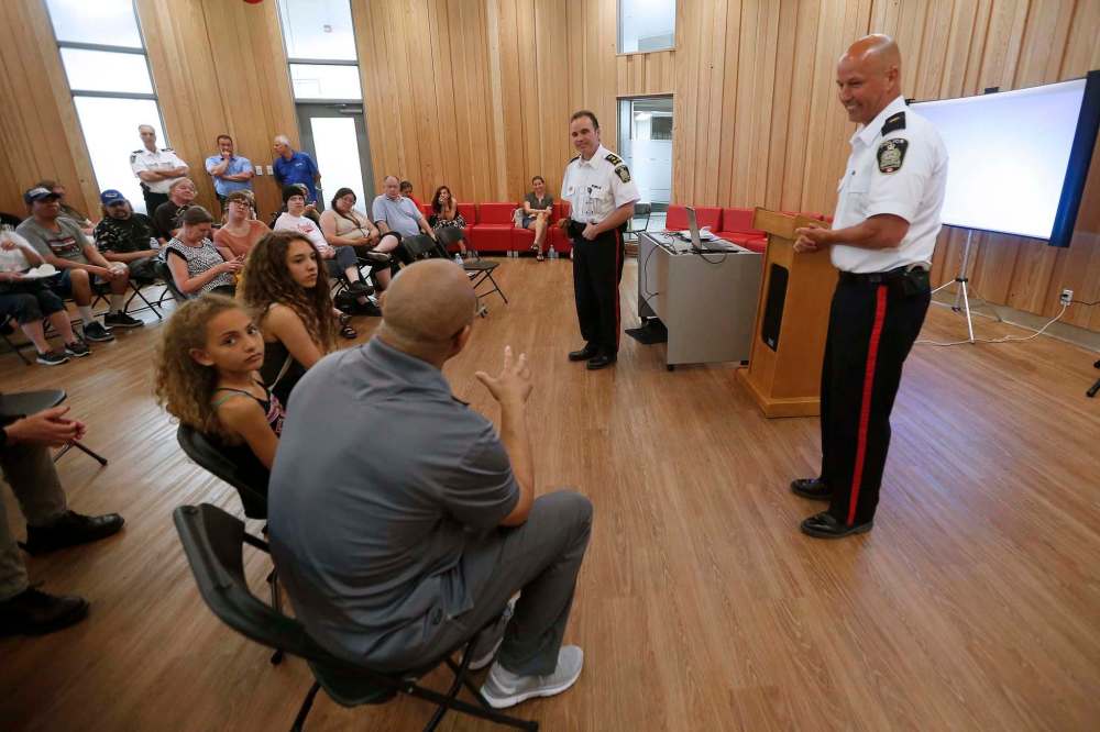 JOHN WOODS / WINNIPEG FREE PRESS
Winnipeg Police chief Danny Smyth (centre) and Inspector Jamie Blunden speak to residents at a community meeting in Winnipeg on Monday.