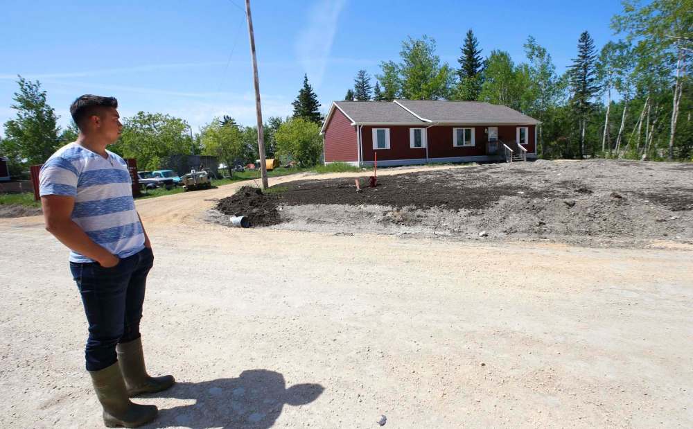 PHOTOS BY WAYNE GLOWACKI / WINNIPEG FREE PRESS FILES
Daniel Stagg of Dauphin River First Nation stands by a new home — one of many built in the community since the flood in 2011 — across the road from his family’s home.