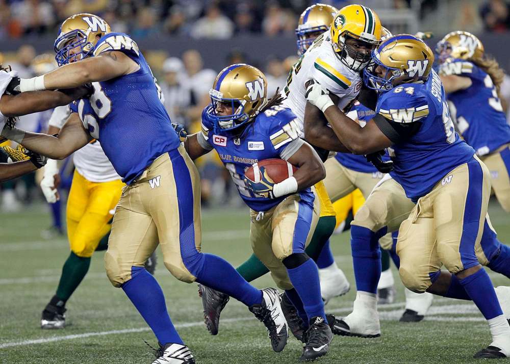 PHIL HOSSACK / WINNIPEG FREE PRESS
Winnipeg Blue Bombers' Kendall Roberson (42) follows his blocker Trevan Brown (58) at Investors Group Field Thursday. Brown has been cut from the roster.