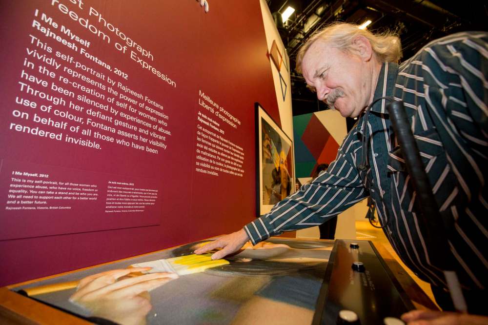JUSTIN SAMANSKI-LANGILLE / WINNIPEG FREE PRESS
Pete Haertel, who is visually impaired, interacts with one of the tactile 3D photo displays inside the new photo exhibition inside the Canadian Museum for Human Rights.
