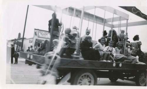 In this shot, you can see my sister Bonnie (centre) wearing a lei and riding a float in the parade.